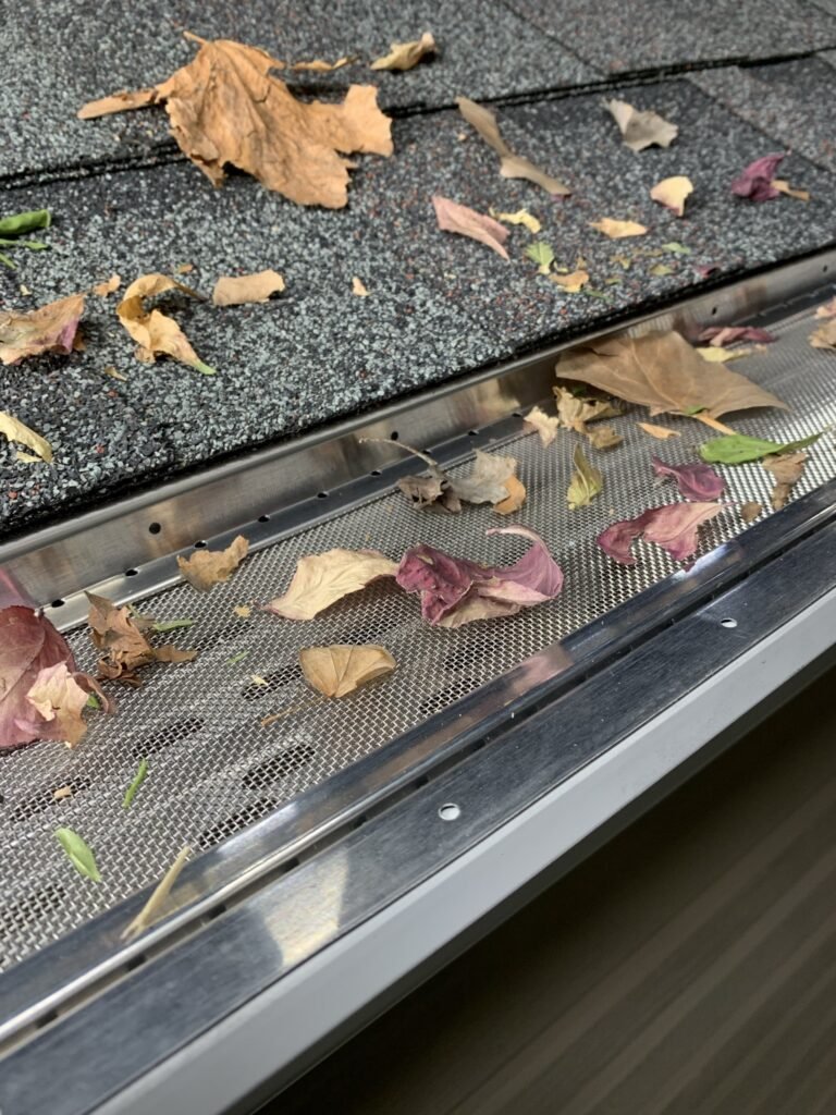 Close-up of a gutter guard installed by The Exterior Zone in Lake Orion, Michigan, preventing leaves and debris from clogging the system.